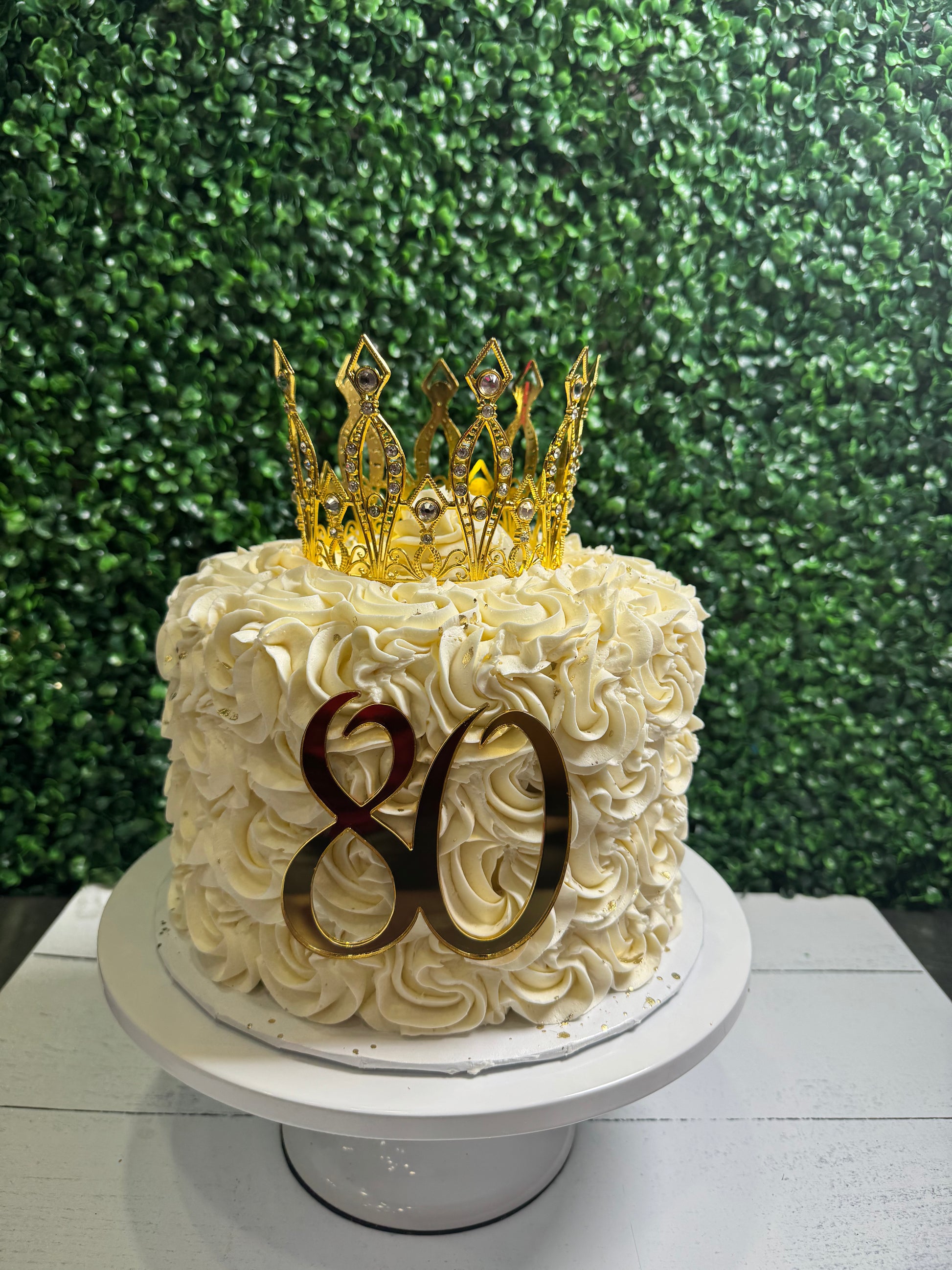 Best white rosette cake with gold crown, number 80, and custom message in Oxford, MS